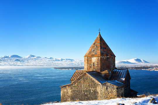 Scenic view of an old Sevanavank church in Sevan, Armenia on sunny winter day blue sky