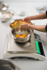 Cropped image of female chef cutting butter in kitchen