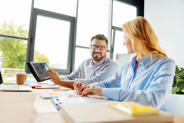 Obraz premium Positive delighted partners working together