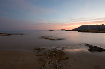 Fototapeta na wymiar Evening sunset over calm beach