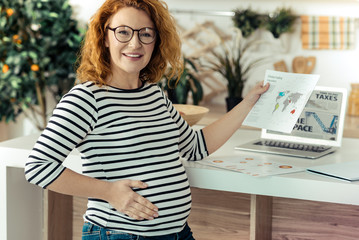 Smart pregnant woman working at home