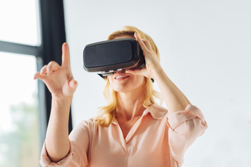 Attractive woman touching virtual mask