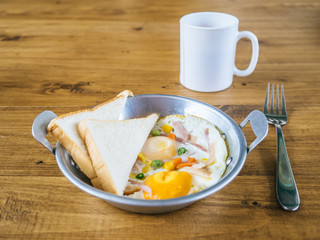 Breakfast set of fried egg and breads.
