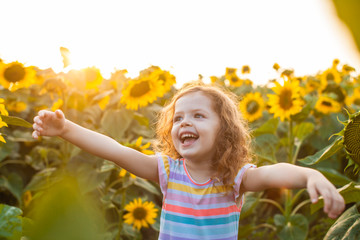 Happy girl is fond of sunflowers