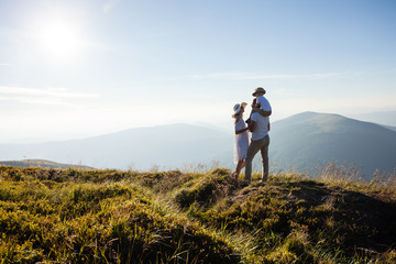 The family admires the mountain landscape