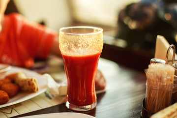 a glass of tomato juice on a table