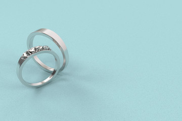 3d rendering. a pair of wedding rings on light blue background.