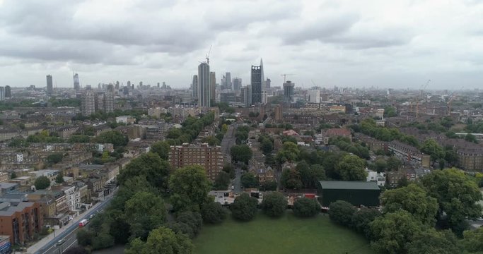 Aerial pull out view of the skyline of the City of London from the South