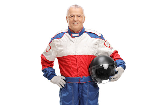 Mature man in a racing suit holding a gray helmet