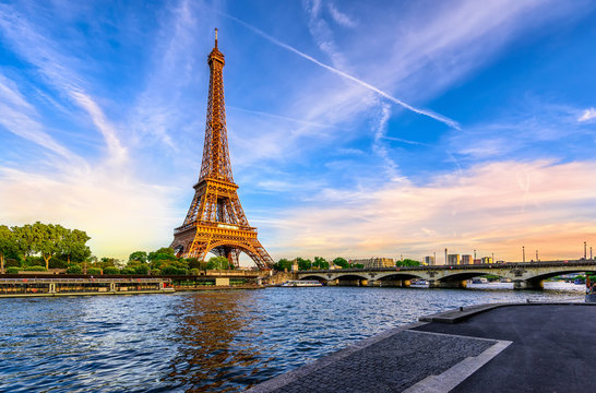 Paris Eiffel Tower and river Seine at sunset in Paris, France. Eiffel Tower is one of the most iconic landmarks of Paris.