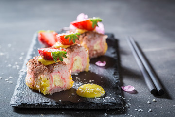 Closeup of sweet sushi made of strawberry and mango