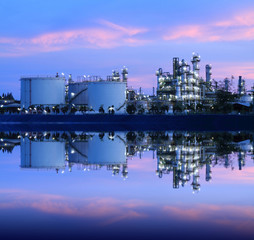 Fototapeta premium Reflection of petrochemical industry on sunset colorful sky