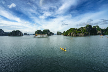 Fototapeta na wymiar Halong bay in Vietnam, UNESCO World Heritage Site, with paddling kayak.