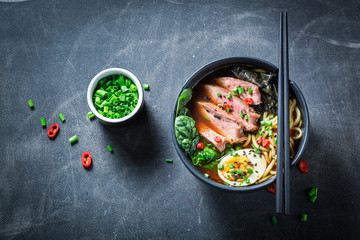Tasty Ramen soup with noodles and spinach