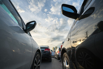 Fototapeta premium Cars on city street in traffic jam at rush hour