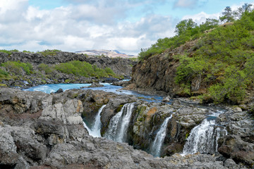 Fototapeta na wymiar Barnafoss waterfall - Western Iceland. Water flows near Barnafoss waterfall, called also 'Waterfall of the children'
