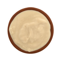 Top view of a small bowl filled with caramel yogurt isolated on a white background.