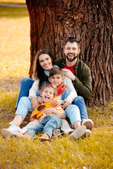 Family sitting together in park