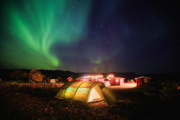 Beautiful picture of massive multicolored green vibrant Aurora Borealis, Aurora Polaris, also know as Northern Lights in the night sky over Norway, Scandinavia © tsuguliev