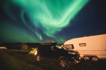 Beautiful picture of massive multicolored green vibrant Aurora Borealis, Aurora Polaris, also know as Northern Lights in the night sky over Norway, Scandinavia