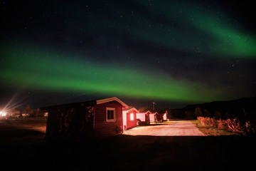 Beautiful picture of massive multicolored green vibrant Aurora Borealis, Aurora Polaris, also know as Northern Lights in the night sky over Norway, Scandinavia