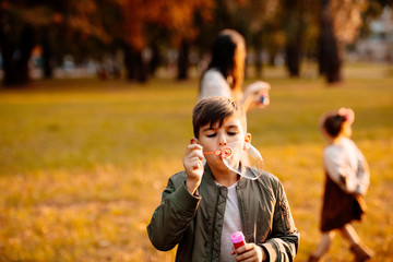 Boy blowing soap bubbles