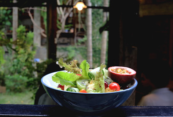Bowl of healthy fresh fruit salad on wooden table, Delicious salad with mix fruit and vegetable, organic salad for healthy 