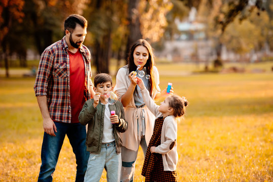 Family with children blowing bubbles
