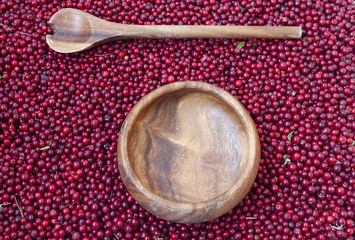 Cowberry berries in a wooden bowl