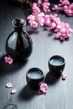 Unfiltered white sake sake with blooming flowers