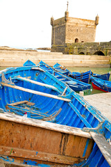   boat and sea in africa morocco old castle brown brick sky