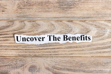 Uncover The Benefits text on paper. Word Uncover The Benefits on torn paper. Concept Image