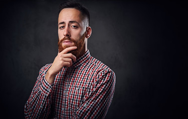 Thoughtful redhead bearded hipster male.