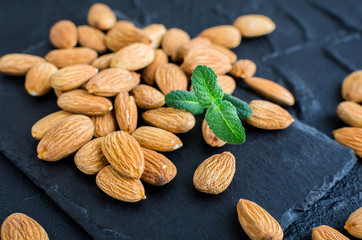 Almonds on the black stone background