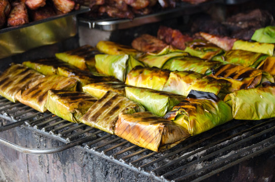 Steamed fish with curry paste in banana leaves wrap (thai food), grilling