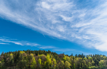 amazing clouds covering an illuminated forest in Bavaria