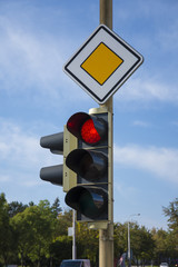 Road signs and traffic lights at a junction in the city