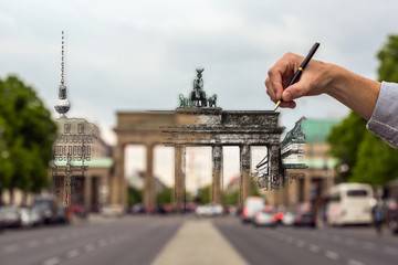 drawing Berlin  a male hand draws the city with a pen © karelian