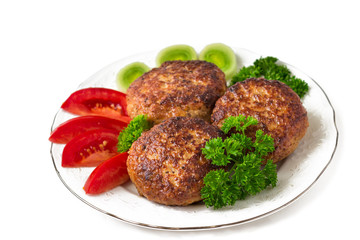 Homemade cutlets with a tomatoes, parsley  on a plate. White background.