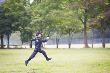 Little girl running in police costume