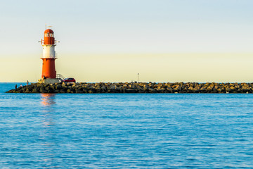 red lighthouse of Warnemuende on the Baltic Sea at the harbor , 