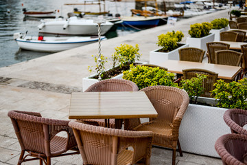 Cafe tables on the quay of Petrovac