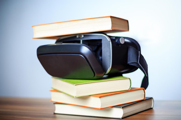 VR glasses and books on a table symbolizing digital learning