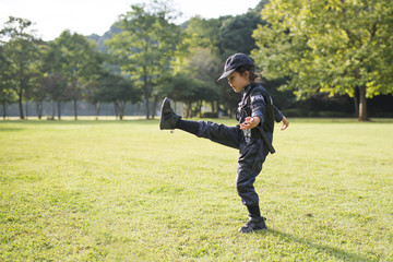 Little girl who kicks in police costume
