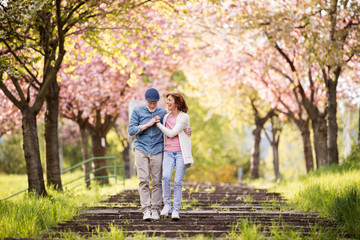 Beautiful senior couple in love outside in spring nature. - Powered by Adobe