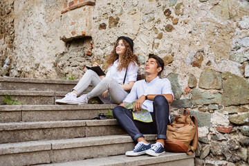 Two young tourists with map in the old town