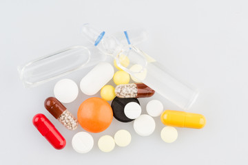 Pills and two ampules on the medical table