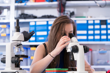 A teenage girl in a school laboratory in chemistry and biology classes