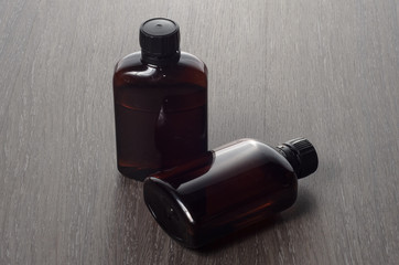 vaping e-cigarette liquid on wooden background