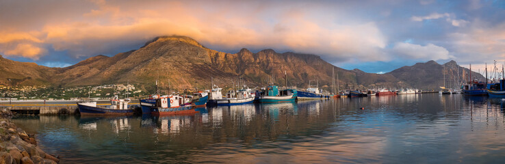 Hout Bay Harbour at sunset, the fishing boats in golden light